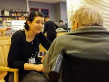 Hoitaja keskustelee vanhuksen kanssa